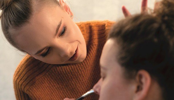 Natasha putting makeup on a client
