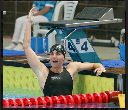 Swimmer celebrating in pool