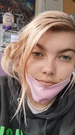 Woman in hospital wearing mask.