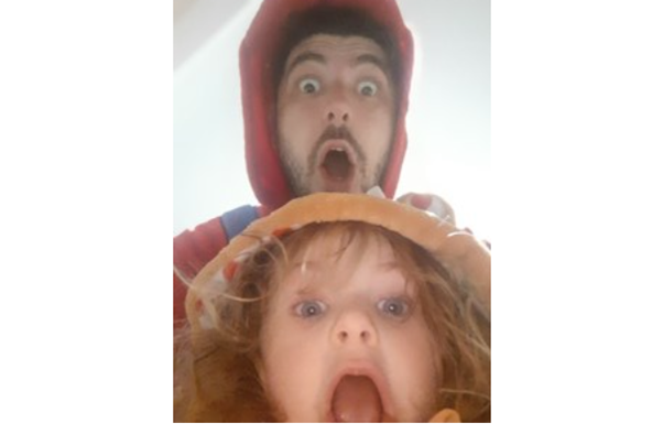 Little girl and her dad with their hoods up