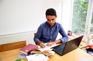 Young man sitting at a desk studying