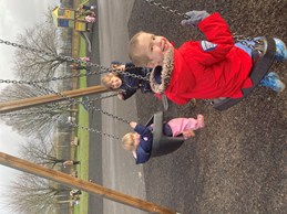 Siblings on swings