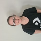 Photo of a young girl wearing a black tshirt and glasses