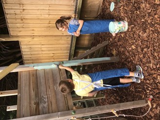 Boy painting outside with sister