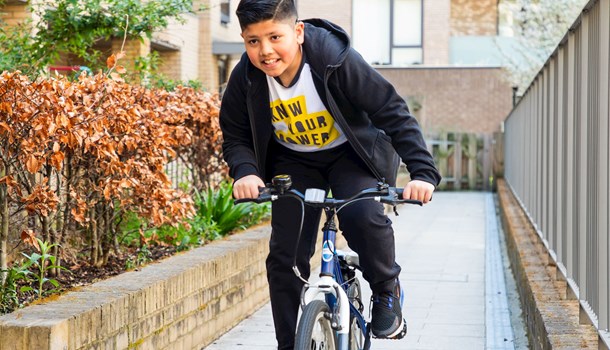 A boy rides his bike. 
