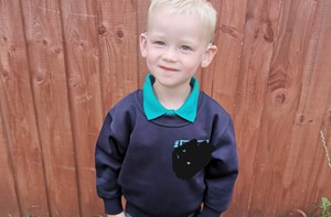Boy outside in new school uniform