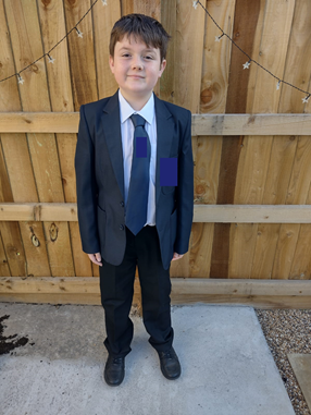 Boy outside in school uniform