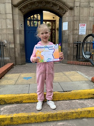 Girl on steps holding certificate