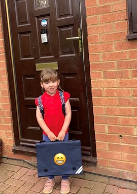 Girl outside door holding folder