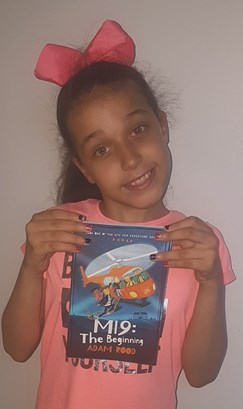 Girl with bow holding MI9 book