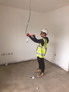 Man in building site with light bulb