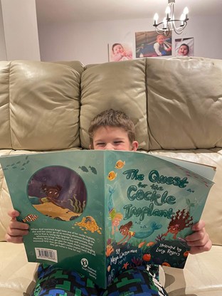 Boy on sofa reading book