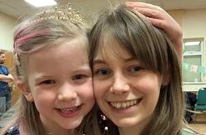 Holly and her 6-year-old daughter Sybil smiling at the camera