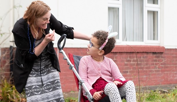 Genevieve (8) sits in a pushchair and looks back at her mother