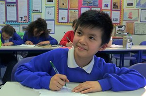 Boy sitting in school classroom