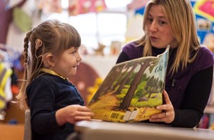 Teacher and deaf child in a classroom