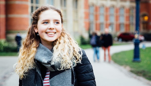 Deaf young person smiling outside university building