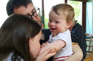 Lucas (10 months) is kissed on the arm by his older sister