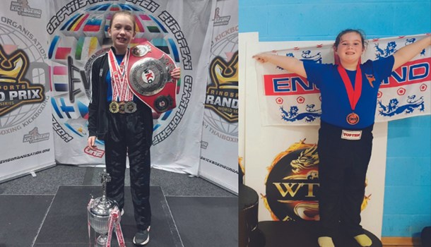 Two deaf young girls posing with their trophies and medals