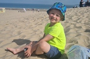 Kenzie (4) sitting on a beach