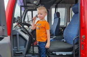 Kenzie (4) in a firetruck playing with the radio