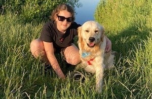 Ffion-Haf (13) kneeling next to her dog