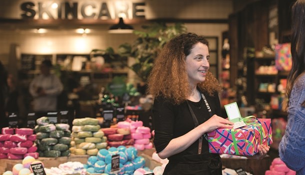 Mollie (19) holding a Lush product at her job