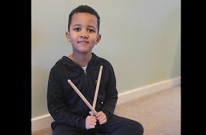 Isaac (6) holding his drumsticks