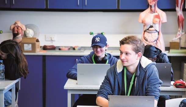 Daniel (18) sits in a science classroom