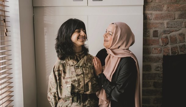 Amani (14) in her RAF uniform standing next to her mum