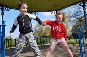 Faith playing with her brother Reuben in a gazebo