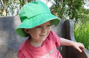 Lucas (2) sitting on a park bench