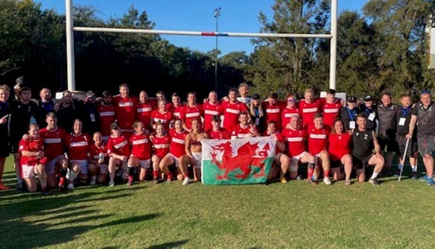 The Wales Deaf rugby team holding the Welsh flag
