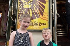 Sybil (6) and brother Francis (4) in front of Lion King poster