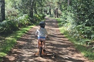 Isabelle (5) cycling down a nature path