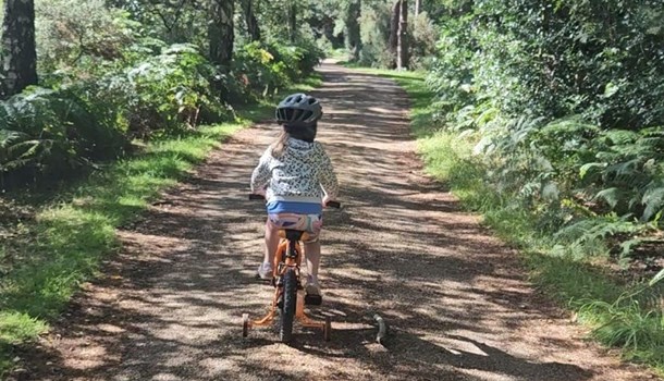 Isabelle (5) cycling down a nature path