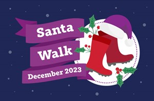 White text on a purple ribbon design: Santa Walk Christmas 2023. Next to it are a pair of red wellies with a Santa hat resting on them surrounded by sprigs of holly