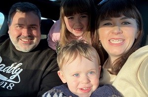 Smiling family with mum, dad, daughter and son