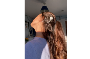 Back of young woman's head showing her cochlear implant