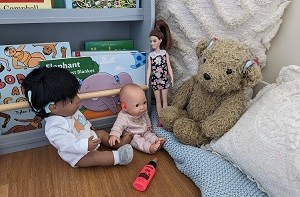 A collections of dolls and teddy bears wearing different hearing technology