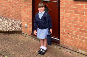 Isabelle (5) standing in front of her house wearing her school uniform.