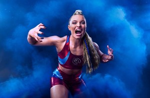 Young woman, with long hair in a ponytail, roaring towards the screen