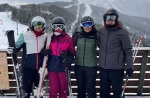 Four people in ski gear on a mountain