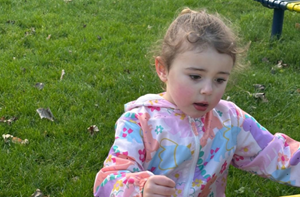 Young girl sitting outside