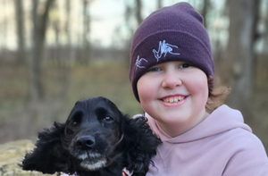 A girl sitting outside with a dog